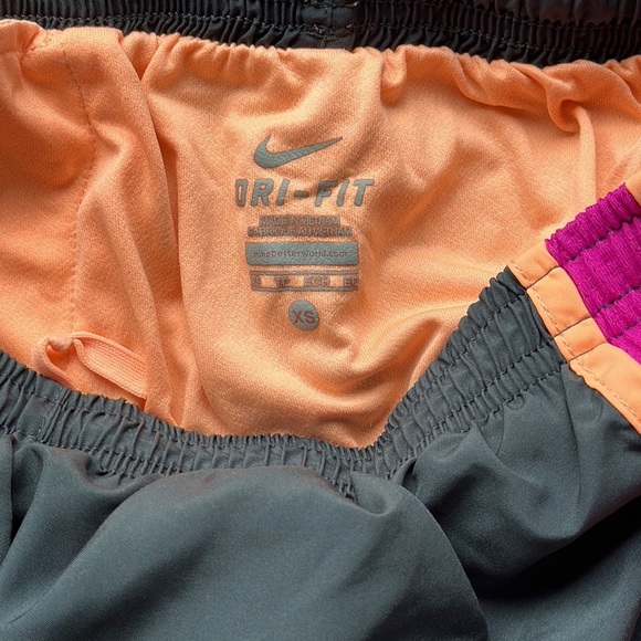 Nike DriFit running shorts in black with purple and orange trim - Picture 6 of 9